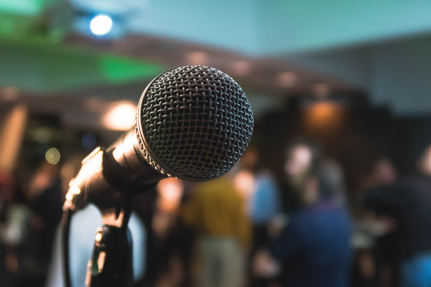 Stage microphone in front of a live conference audience