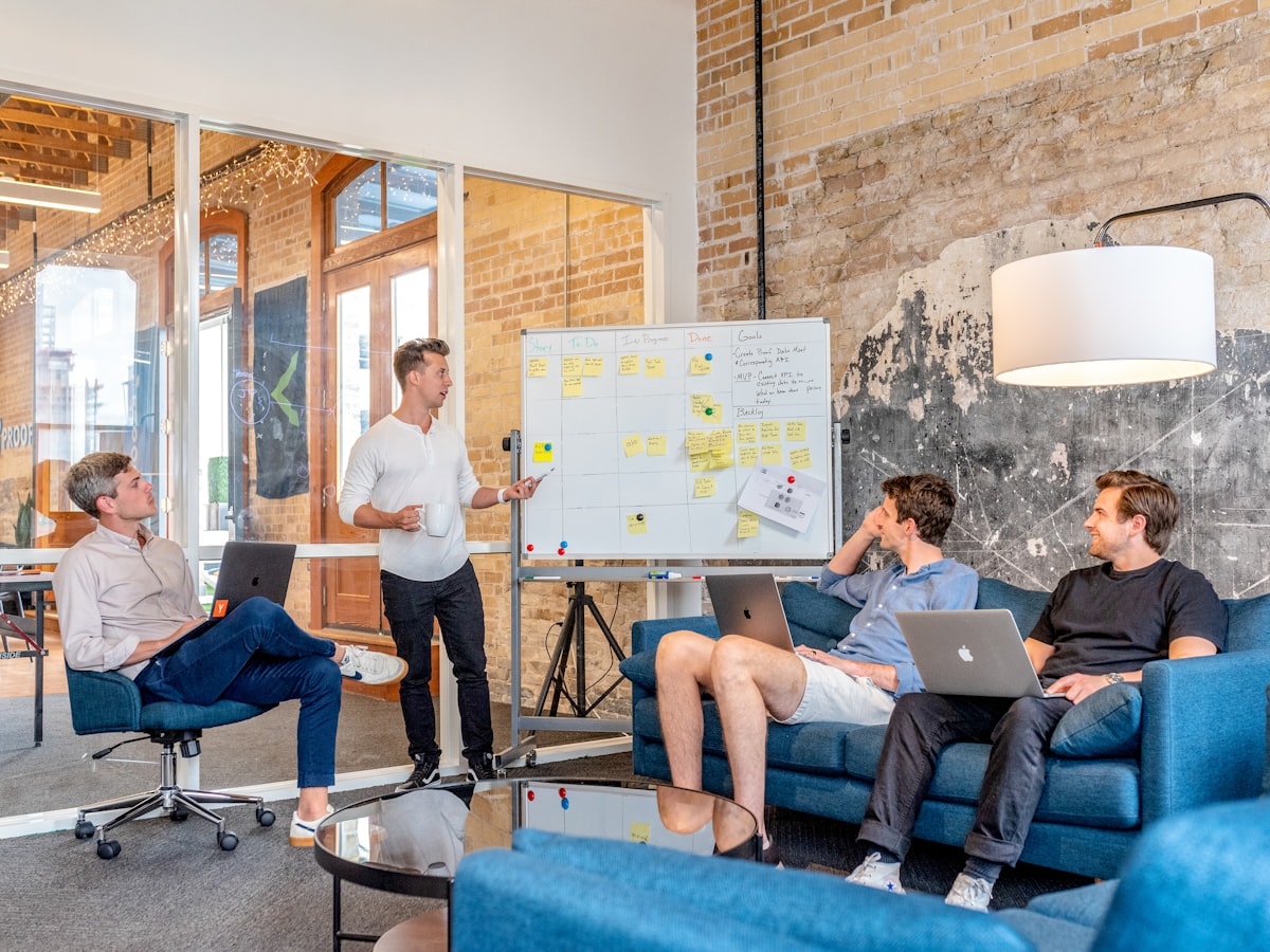 Team reviewing a brand rollout plan on a whiteboard